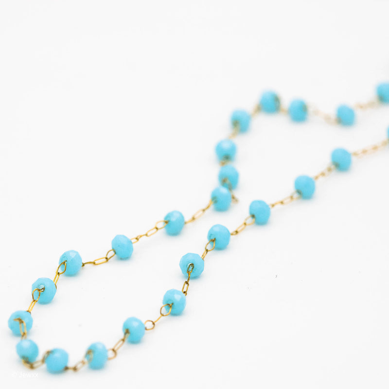 Collier Douceur en acier inoxydable doré et perles synthétiques bleu.